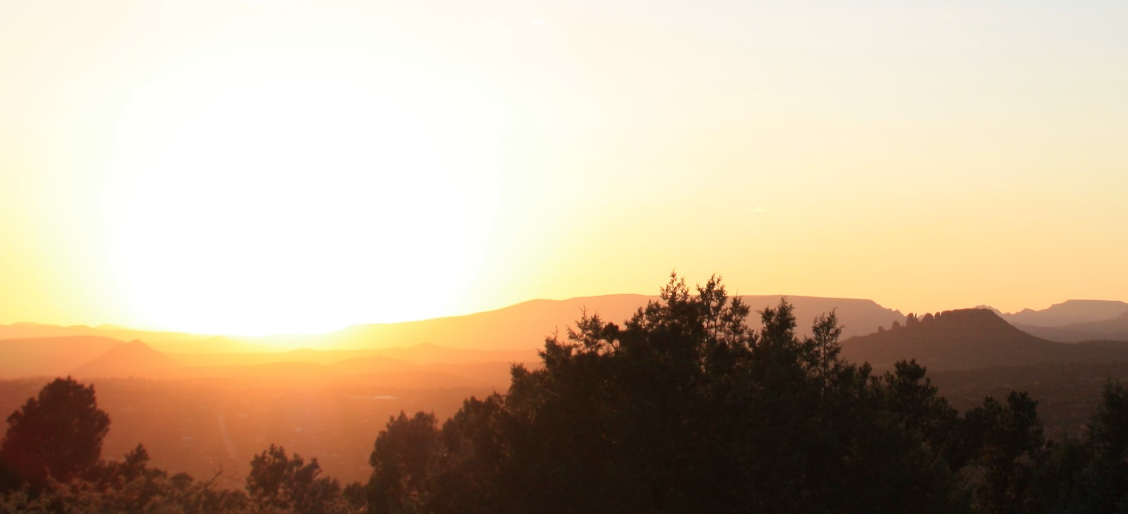 Sunset over mountains and trees