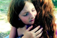 two girls hug in forgiveness