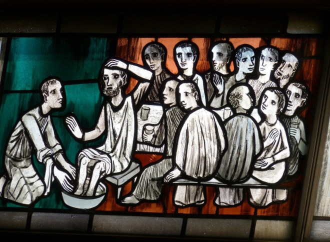 stain glass representation of jesus washing disciples feet