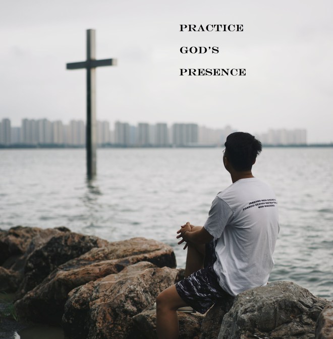 person comtemplatin cross with bay and city in background