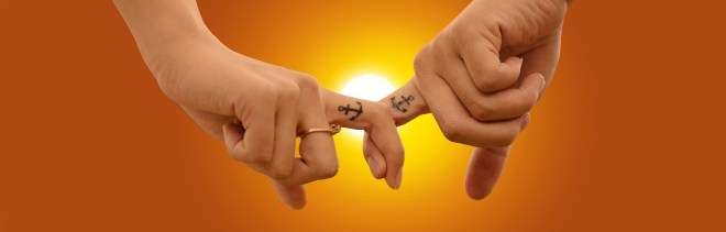 fingers crossed anchor tatoo sun in background
