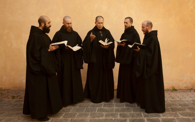 5 monks holding books